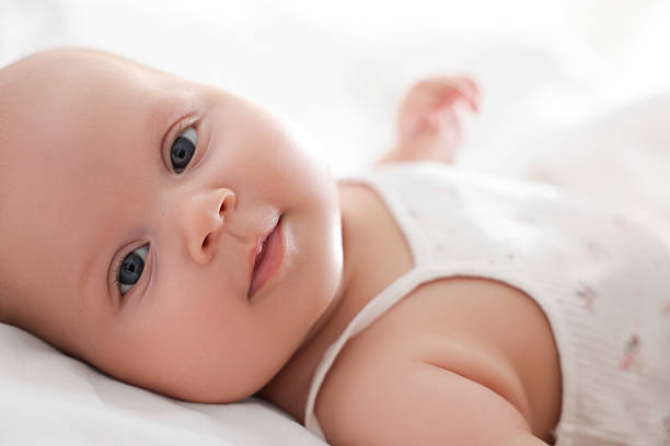 istock Cute little baby lying on bed at home 2224877675