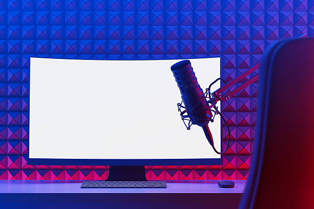 Empty soundproof control room in professional recording studio, stereo equipment with sliders and faders on panel board. Professional post production space with audio recording software.