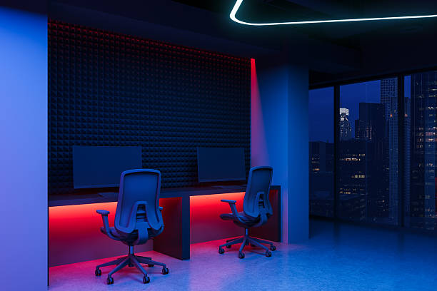 istock Futuristic office space with dual workstations and neon lighting in high-rise cityscape at night. 3D Rendering 2224877956