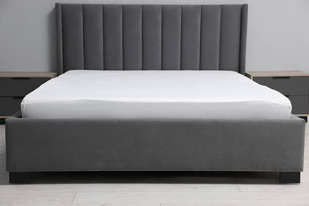 istock Comfortable bed with clean linens at home 2224877979