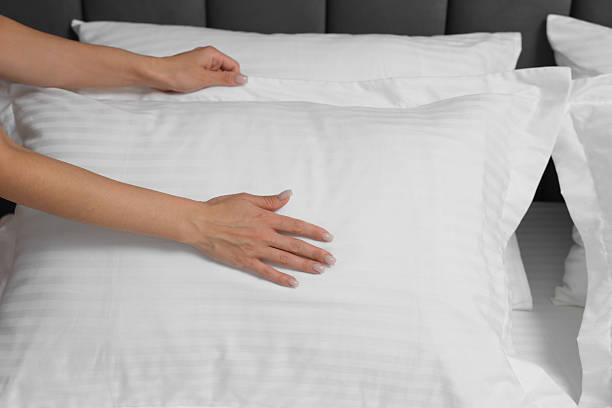 istock Woman changing clean bed linens at home, closeup 2224877986