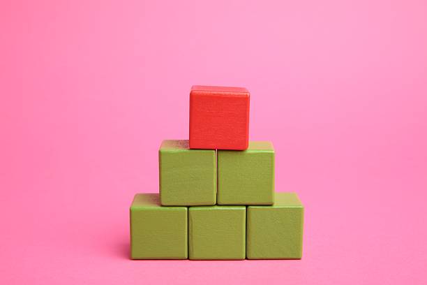 Pyramid of colorful cubes on pink background