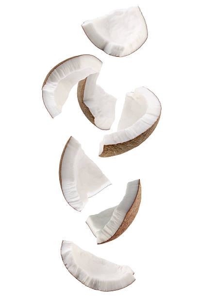 istock Pieces of coconut falling in space. Isolated on white 2224880917