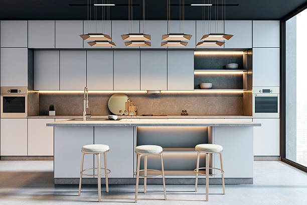 istock Modern elegant kitchen interior with island, stools, and backlit cabinets in high-rise home with large window and cozy city view background. 3D Rendering 2224880936