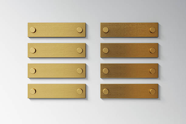 Eight blank golden metal signage plates on light wall background, clean front view layout for office branding or nameplate mockup concept, 3D Rendering