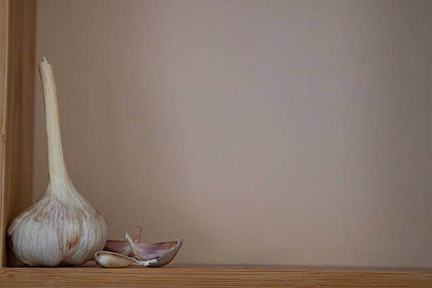 Garlic bulbs with cloves isolated on white background. White garlic bulb composition. Studio shot. High angle view.