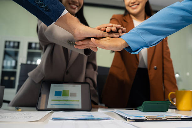 istock business people holding each others wrists, join hands together, support and unity, team strength and power, colleagues involved in team building activity. 2224882453