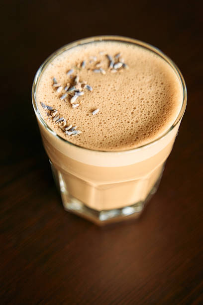 Creamy iced coffee with chocolate shavings and smooth foam topped glass