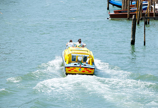 Venice, Italy - June 24, 2025: Speedboat carrying passengers is moving swiftly through clear waters, creating a wake, capturing the essence of summer adventure