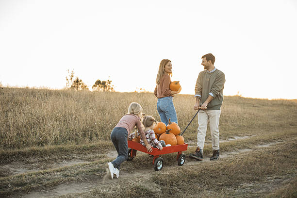 istock Young family at pumpkin patch 2224886596