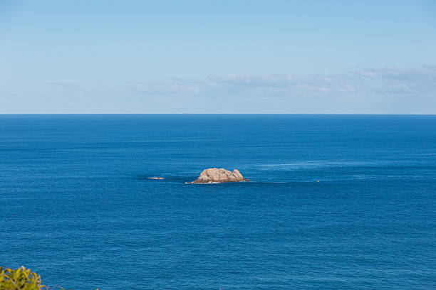 A big rock in the sea.