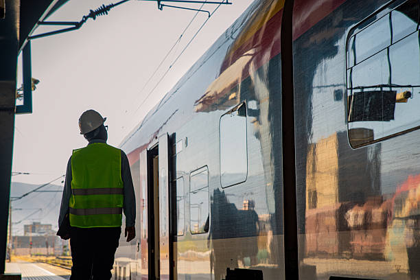 istock Engineer on the train station inspecting the train 2224887156