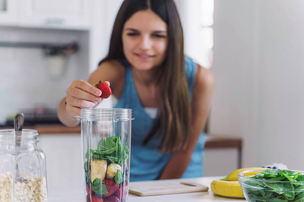 istock Focused Girl Preparing Healthy Smoothie in Kitchen 2224887253