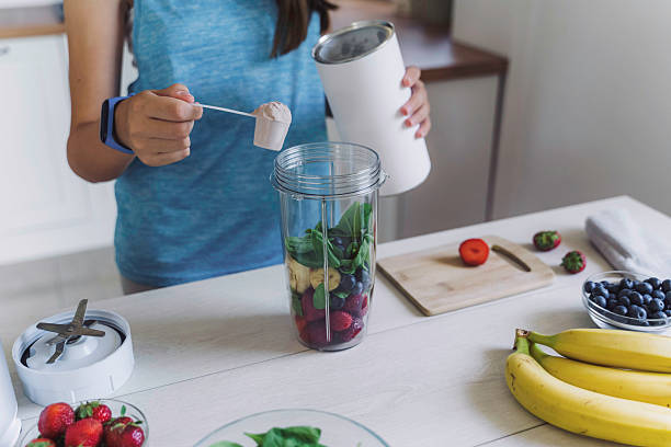 istock Bright Kitchen with Girl Making Smoothie 2224887261