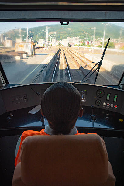 Female locomotive engineer in the train control cabin, preparing to go