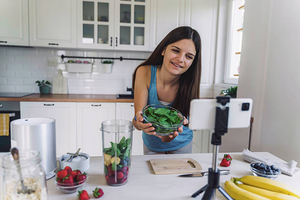 istock Young Girl Showcasing Spinach in Bright Kitchen 2224887682