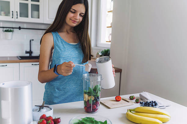 istock Young Girl Preparing a Nutritious Smoothie 2224887698