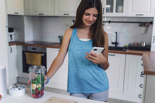 istock Girl enjoying smoothie creation with digital devices 2224887712