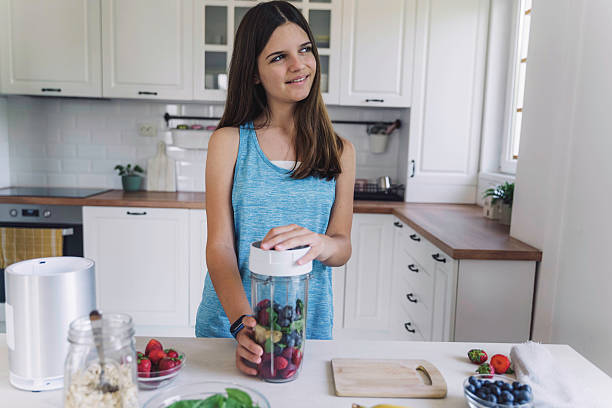 istock Girl Preparing Smoothie with Fresh Ingredients 2224887716