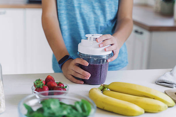 istock Hands Holding Smoothie Jar with Fresh Ingredients 2224887734