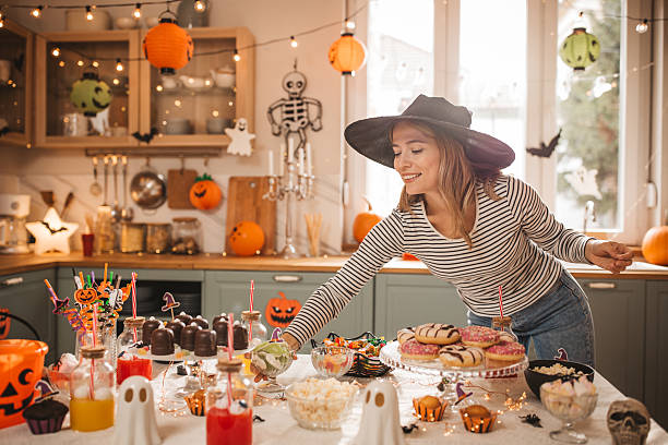 Woman preparing food table for Halloween