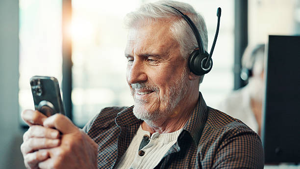 istock Call center, headset and man typing with phone for customer service break, text message and mobile chat. Agent, mature person and happy with smartphone for social media scroll and check notifications 2224890593