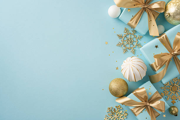 istock Flat lay image featuring luxurious gifts with gold ribbons and snowflake decorations, ideal for holiday themes 2224893357