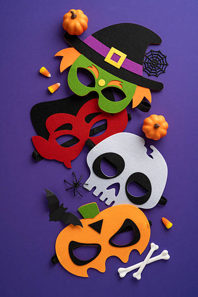 istock Halloween-themed vertical paper masks include pumpkin, witch, skull, and bat designs with holiday decorations 2224893368