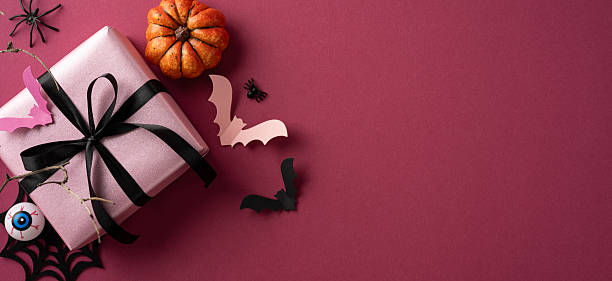 istock Festive Halloween-themed arrangement featuring a pink gift box with decorations such as bats, a pumpkin, and a spider on a vivid background enhancing the Halloween holiday vibe 2224893391