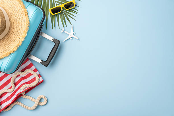 istock Travel essentials such as a suitcase and summer accessories with a tropical vacation theme 2224893429