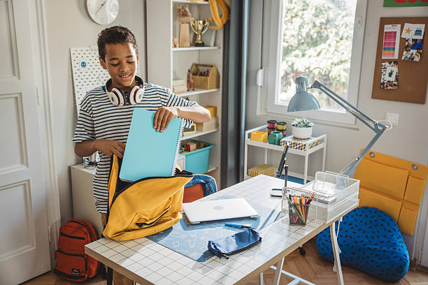 istock Teenage boy packing for school 2224893734
