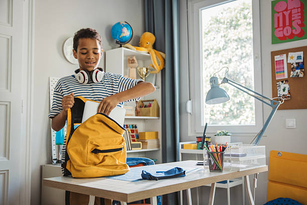 istock Teenage boy packing for school 2224893739