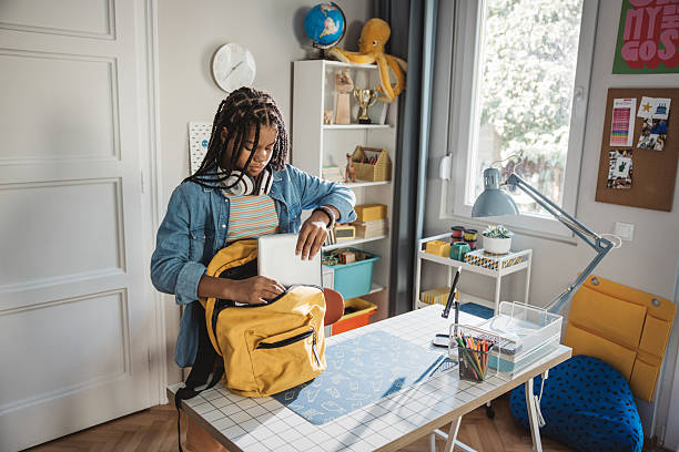 istock Teenage girl packing backpack for school 2224893766