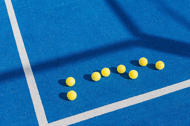 istock Padel Balls Lined up for a Training Drill on a Blue Court. 2224893808