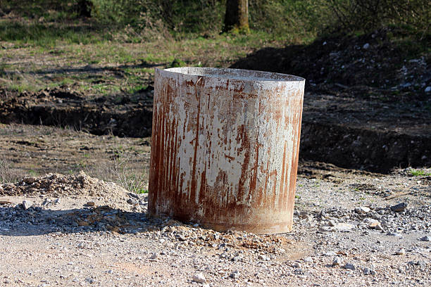 istock Rusted cylindrical steel formwork on gravel at construction site 2224895796