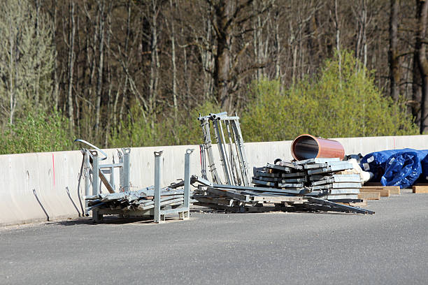 istock Stacked metal scaffolding and pipe on roadside construction site 2224896182