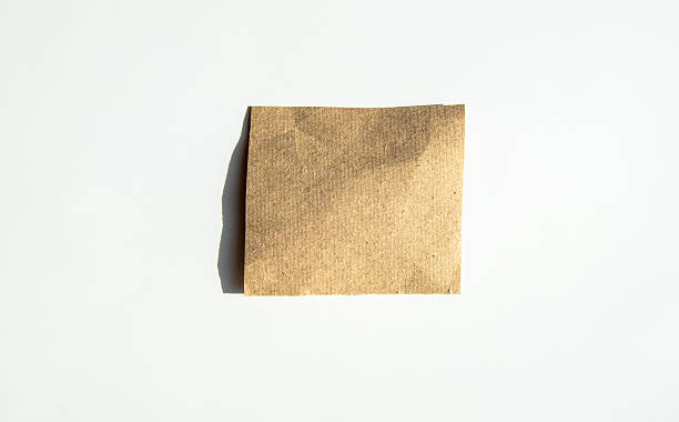 istock Square kraft sticker, sheet of brown note paper, isolated on a white background 2224897245