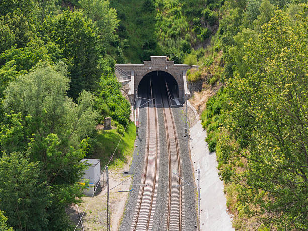 istock Railway tunnel surrounded by lush greenery near hillside reveals modern rail infrastructure in a tranquil setting 2224897722