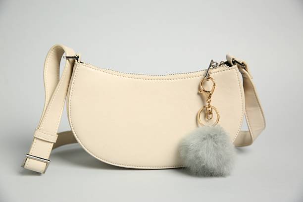 istock Leather bag with faux fur keychain on grey background 2224897876