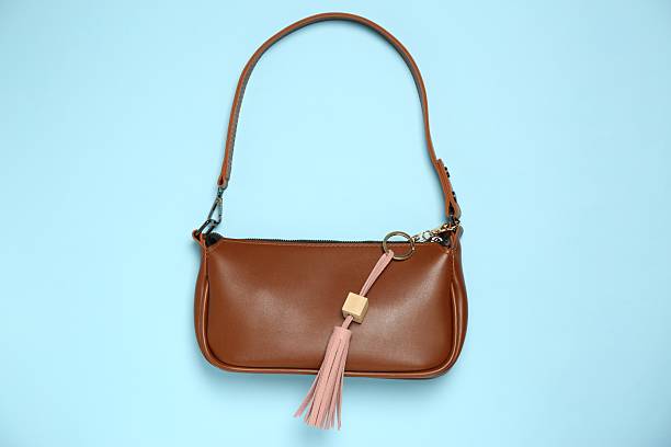 istock Bag with pink leather keychain on light blue background, top view 2224897885