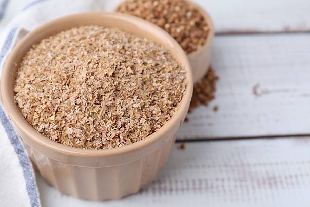 istock Buckwheat bran in bowl on white wooden table, closeup. Space for text 2224898085