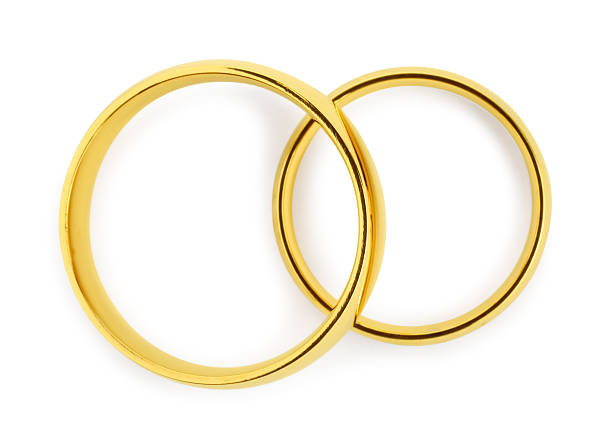 istock Beautiful golden wedding rings isolated on white, top view 2224898371