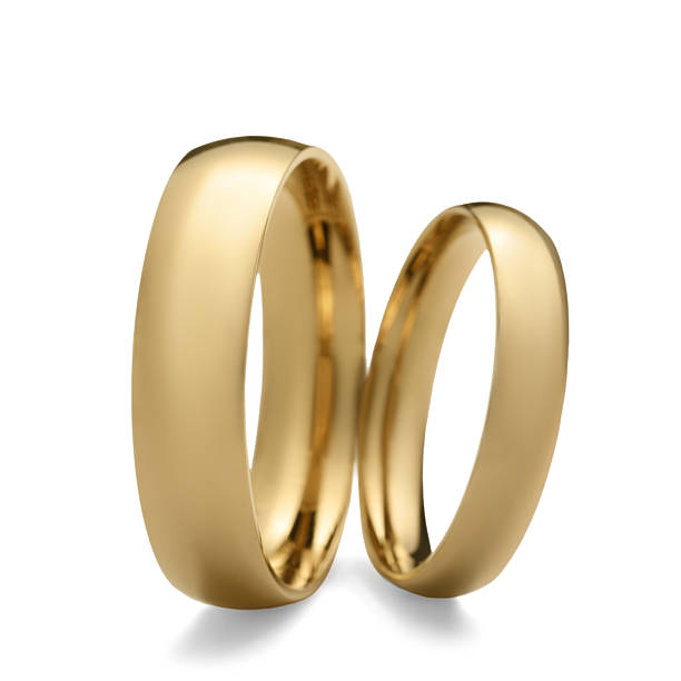 istock Beautiful golden wedding rings isolated on white 2224898421