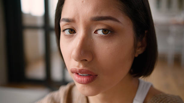 istock Sad upset worried frustrated thinking problem bad mood sorrow grief emotions portrait Hispanic Latina woman girl female looking at camera face close up at home medicine loan mortgage health problem 2224899427