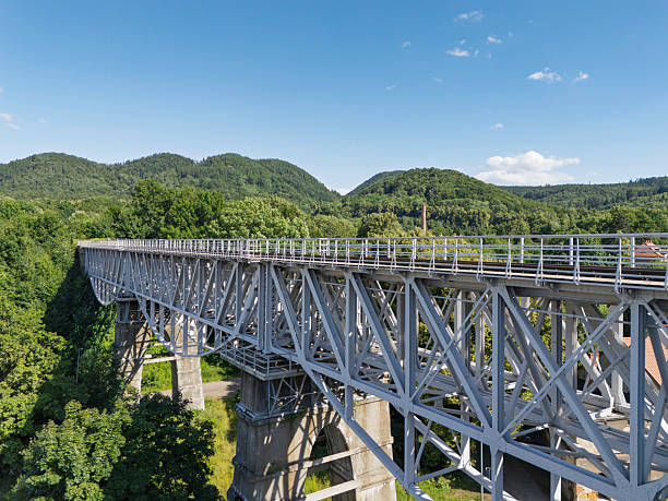 istock Rail bridge spans lush valley in scenic landscape showcasing modern infrastructure and natural beauty during bright daytime 2224899938