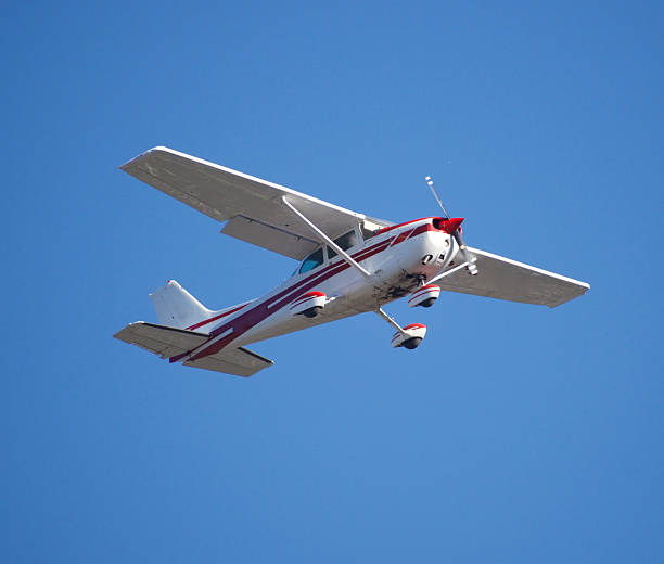 istock white Cessna Skyhawk plane with red lines flying low 2224900851