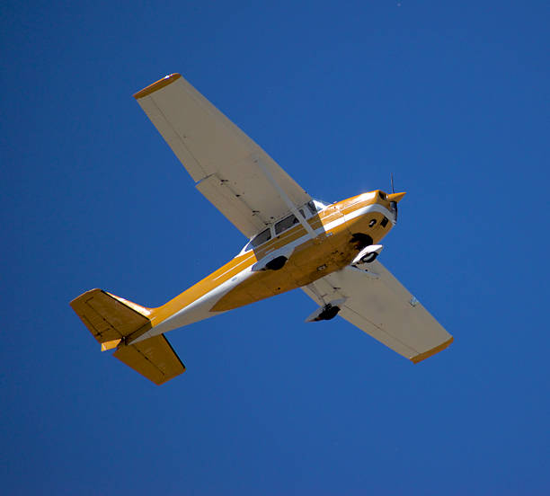 istock Yellow Cessna 172 Skyhawk soaring through the sky 2224900942