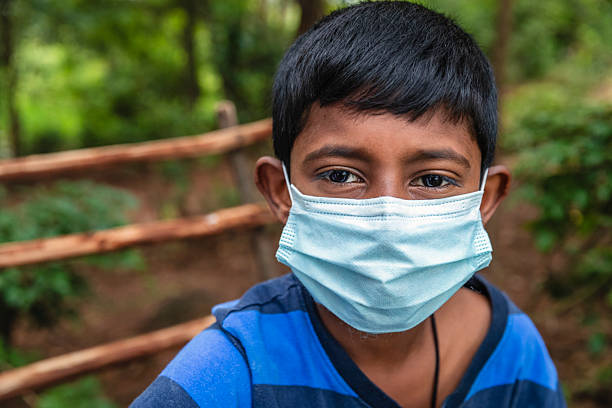 Sri Lankan young boy wearing face mask, Sigiriya, Ceylon (Sri Lanka)
