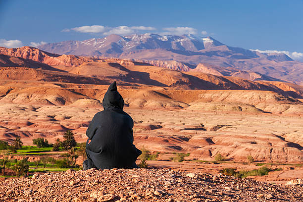 istock Maroccan man looking at High Atlas mountain range 2224904774