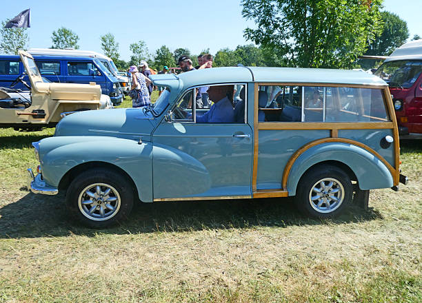 Garching, Germany - Oldtimer car exhibition 2025, July 4th: light blue vintage MORRIS MINOR 1000 TRAVELLER woody station wagon, 60s, lateral view